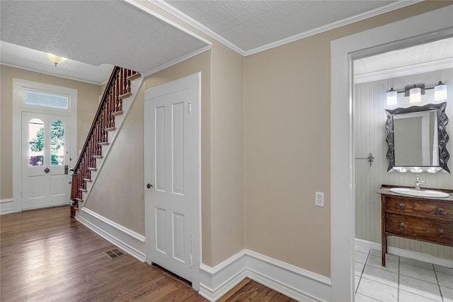 401 N Benge, Mckinney, TX 75069 - entrance foyer featuring stairway, light wood-style floors, and crown molding
