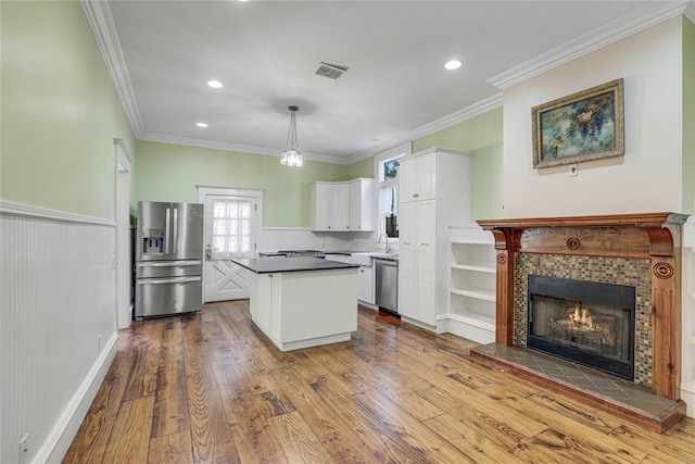 401 N Benge, Mckinney, TX 75069 - kitchen with stainless steel appliances, white cabinets, dark wood-type flooring, crown molding, and a kitchen island