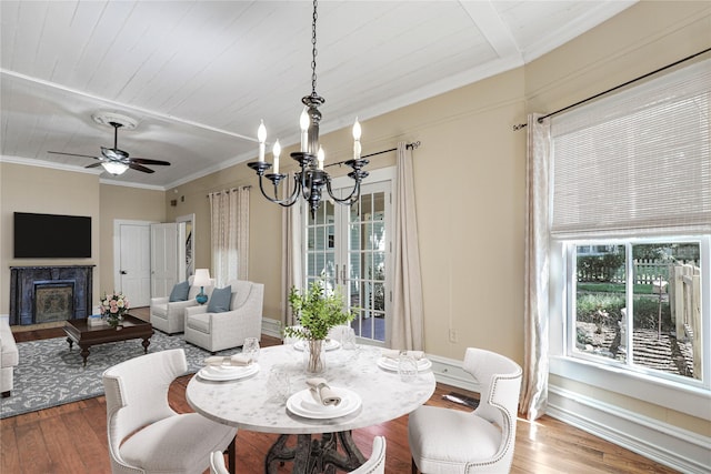 401 N Benge, Mckinney, TX 75069 - dining room featuring wood finished floors, ornamental molding, a chandelier, a ceiling fan, and a high end fireplace