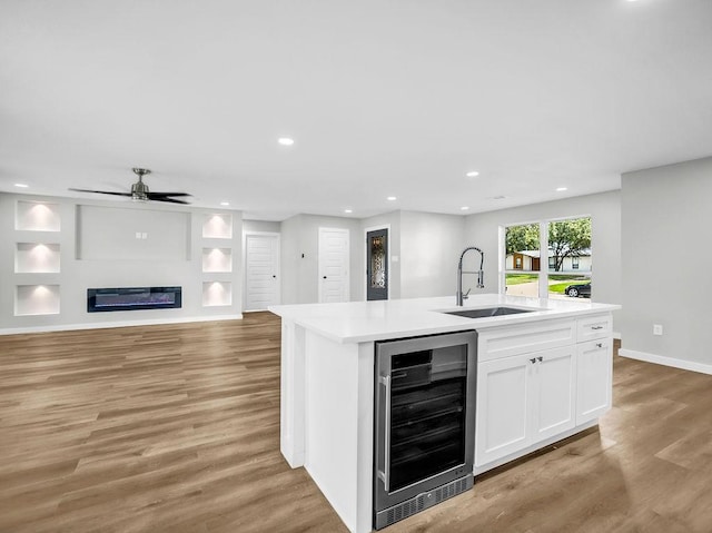 3505 Morningstar Ln, Farmers Branch, TX 75234 - kitchen featuring wine cooler, light wood-style flooring, open floor plan, white cabinetry, and light countertops