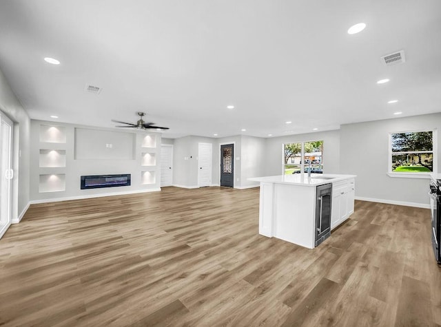 3505 Morningstar Ln, Farmers Branch, TX 75234 - kitchen with beverage cooler, light wood-style floors, recessed lighting, light countertops, and ceiling fan
