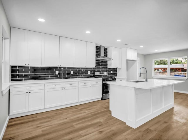 3505 Morningstar Ln, Farmers Branch, TX 75234 - kitchen with stainless steel gas range oven, wall chimney exhaust hood, light wood-style flooring, white cabinets, and tasteful backsplash