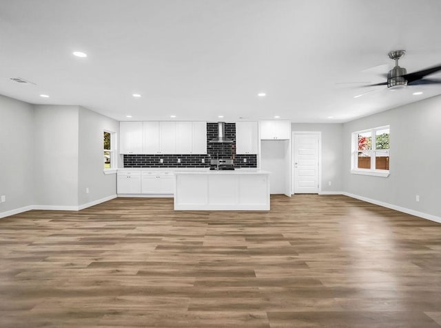 3505 Morningstar Ln, Farmers Branch, TX 75234 - kitchen featuring wall chimney exhaust hood, open floor plan, white cabinetry, and recessed lighting