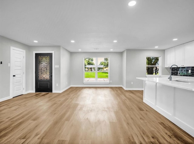 3505 Morningstar Ln, Farmers Branch, TX 75234 - unfurnished living room featuring recessed lighting, light wood-type flooring, and healthy amount of natural light