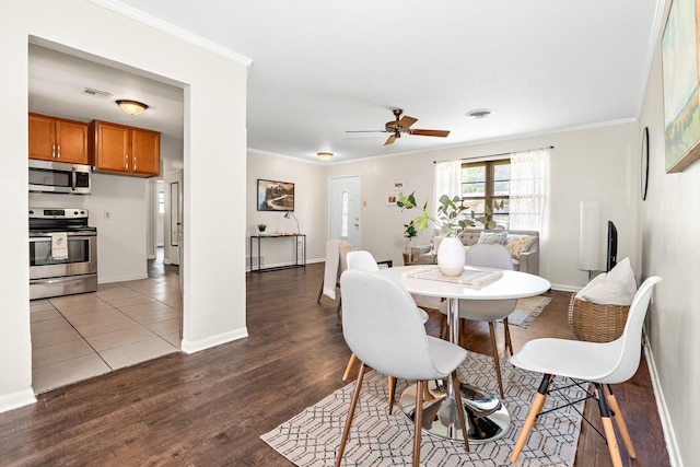 301 Sunset Blvd, Hewitt, TX 76643 - dining area with crown molding, a ceiling fan, and wood finished floors