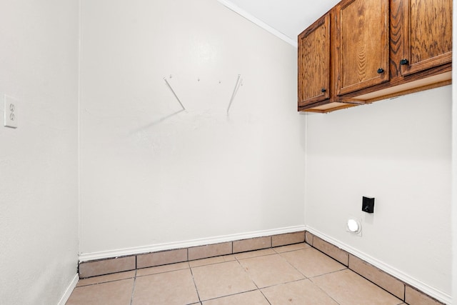 301 Sunset Blvd, Hewitt, TX 76643 - laundry room with cabinet space, light tile patterned flooring, hookup for an electric dryer, and ornamental molding