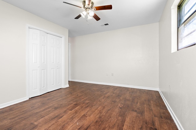 301 Sunset Blvd, Hewitt, TX 76643 - unfurnished bedroom with dark wood-style floors, a closet, and a ceiling fan