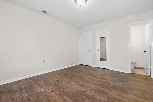 301 Sunset Blvd, Hewitt, TX 76643 - unfurnished bedroom with wood finished floors and ensuite bathroom