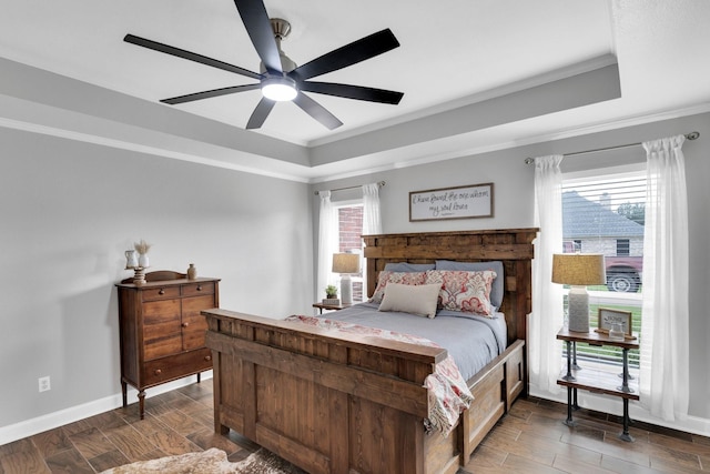5631 Mission Ct, Midlothian, TX 76065 - bedroom featuring a tray ceiling, wood finished floors, multiple windows, and ornamental molding