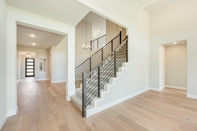 5202 Rowlan Row, Midlothian, TX 76065 - stairs featuring a chandelier, wood finished floors, and recessed lighting