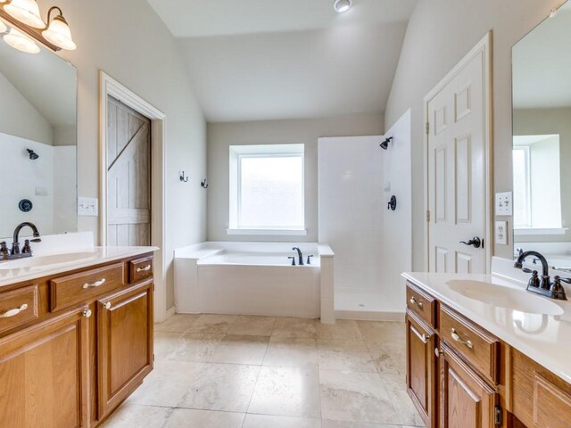 6505 Tamarron Ln, Plano, TX 75024 - full bath with vaulted ceiling, a garden tub, tiled shower, and two vanities