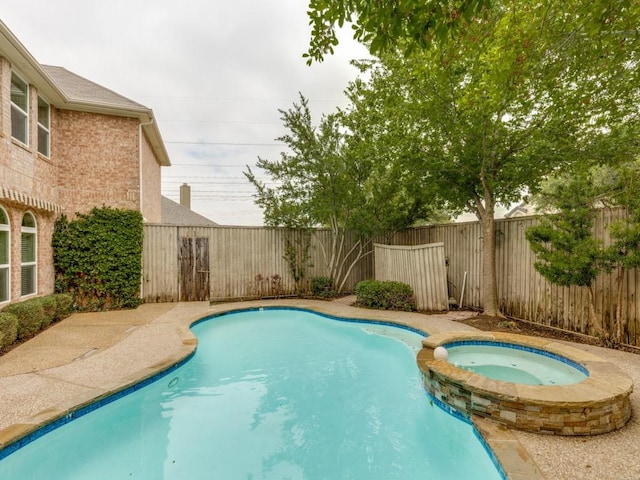 6505 Tamarron Ln, Plano, TX 75024 - view of swimming pool with a pool with connected hot tub and a fenced backyard