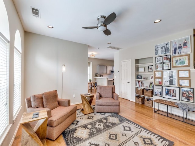 6505 Tamarron Ln, Plano, TX 75024 - living area with a ceiling fan, plenty of natural light, wood finished floors, recessed lighting, and built in features