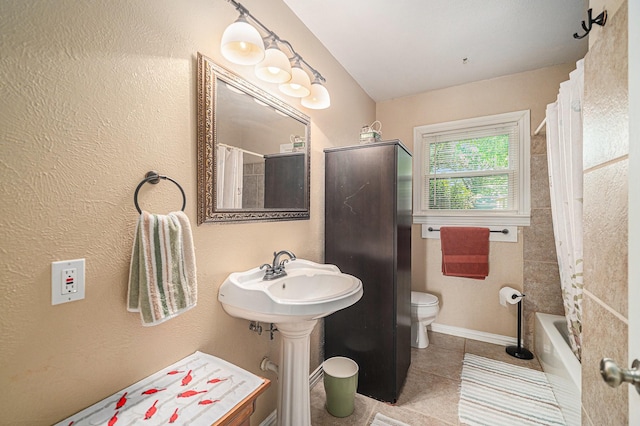 504 Harrison Ln, Hurst, TX 76053 - bathroom featuring tile patterned floors and shower / bath combination with curtain