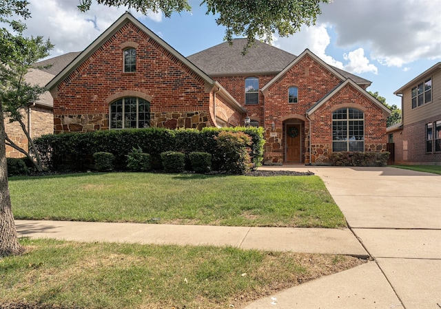 4748 Mcbreyer Pl, Fort Worth, TX 76244 - view of front of house featuring a front lawn, brick siding, stone siding, and a shingled roof