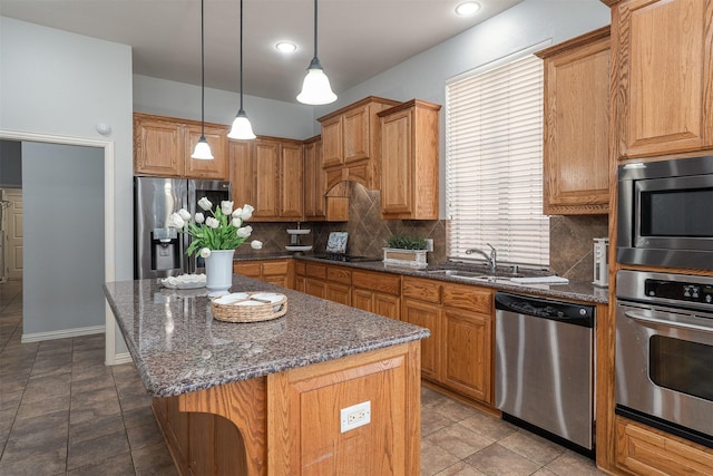4748 Mcbreyer Pl, Fort Worth, TX 76244 - kitchen featuring appliances with stainless steel finishes, backsplash, a kitchen island, dark stone counters, and hanging light fixtures
