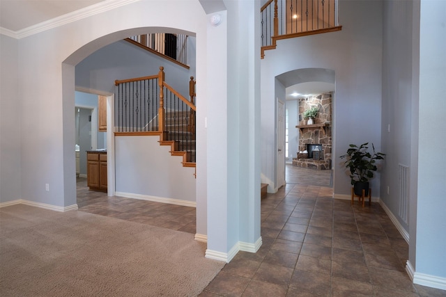 4748 Mcbreyer Pl, Fort Worth, TX 76244 - hall with arched walkways, stairway, a towering ceiling, ornamental molding, and carpet flooring