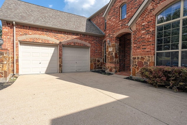4748 Mcbreyer Pl, Fort Worth, TX 76244 - view of front of property featuring roof with shingles, brick siding, driveway, a garage, and stone siding