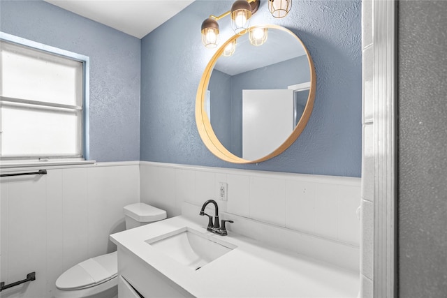 1914 Normandy Dr, Irving, TX 75060 - half bath with a textured wall, vanity, and a wainscoted wall