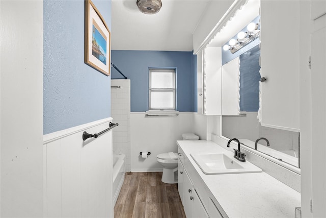 1914 Normandy Dr, Irving, TX 75060 - full bath featuring vanity, wood finished floors, a wainscoted wall, and  shower combination
