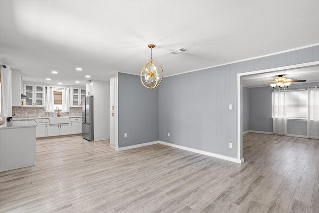 1914 Normandy Dr, Irving, TX 75060 - unfurnished living room with a chandelier, light wood-style floors, recessed lighting, and a ceiling fan