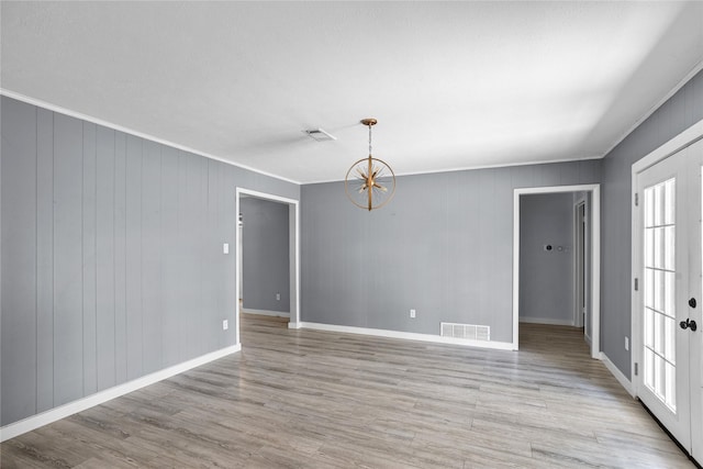 1914 Normandy Dr, Irving, TX 75060 - unfurnished room featuring ornamental molding, light wood-type flooring, and a chandelier