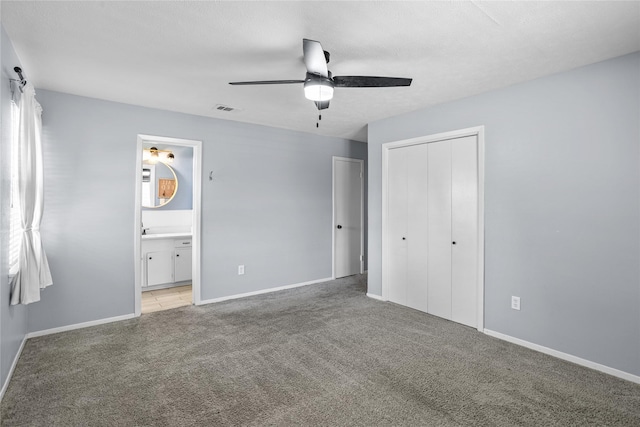 1914 Normandy Dr, Irving, TX 75060 - unfurnished bedroom featuring light colored carpet, a closet, ensuite bath, and a ceiling fan