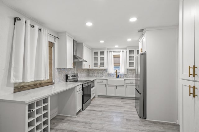 1914 Normandy Dr, Irving, TX 75060 - kitchen featuring appliances with stainless steel finishes, wall chimney exhaust hood, white cabinets, glass insert cabinets, and tasteful backsplash