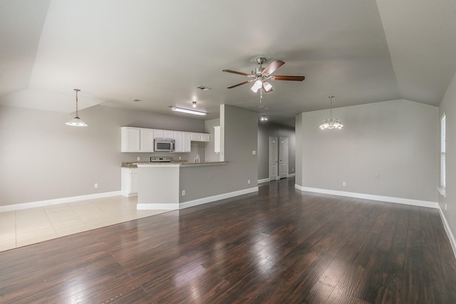 1102 David Dr, Euless, TX 76040 - unfurnished living room featuring lofted ceiling, a ceiling fan, hardwood / wood-style floors, and a chandelier