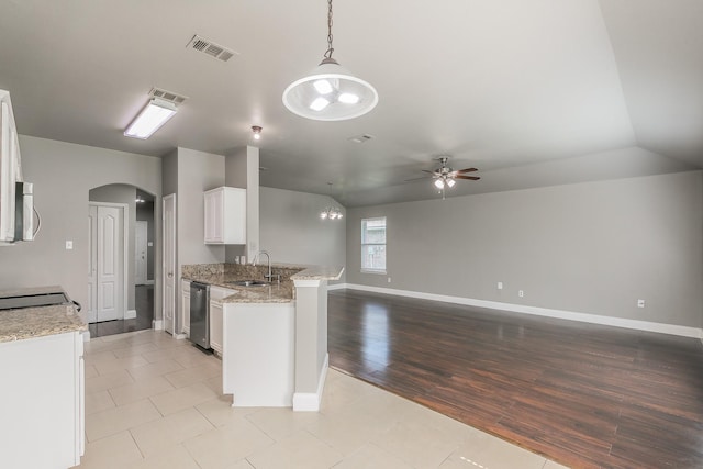 1102 David Dr, Euless, TX 76040 - kitchen featuring appliances with stainless steel finishes, a ceiling fan, arched walkways, white cabinets, and a peninsula