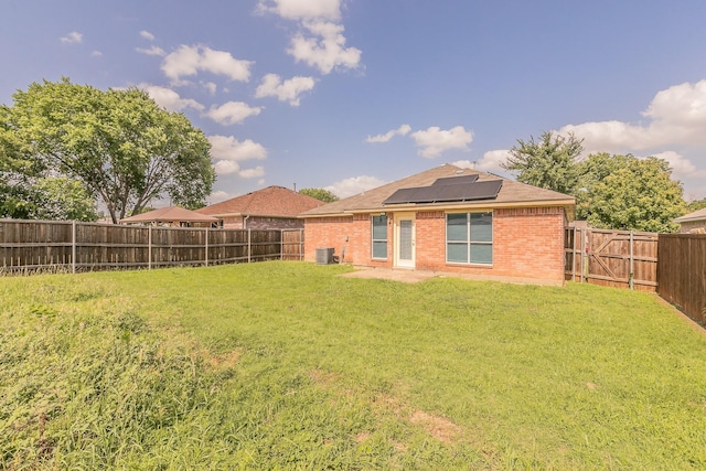 1102 David Dr, Euless, TX 76040 - rear view of property featuring brick siding, a fenced backyard, solar panels, and a shingled roof