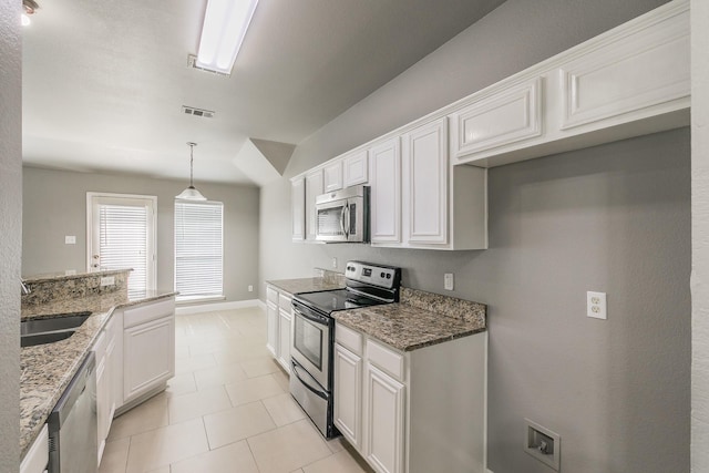 1102 David Dr, Euless, TX 76040 - kitchen with appliances with stainless steel finishes, light stone counters, white cabinetry, and hanging light fixtures