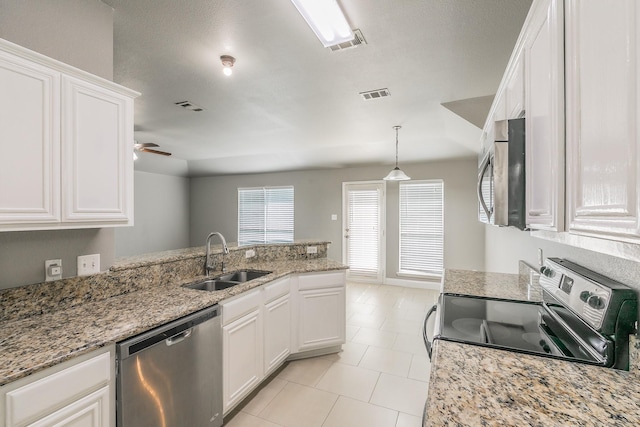 1102 David Dr, Euless, TX 76040 - kitchen featuring appliances with stainless steel finishes, white cabinetry, ceiling fan, light stone countertops, and a peninsula