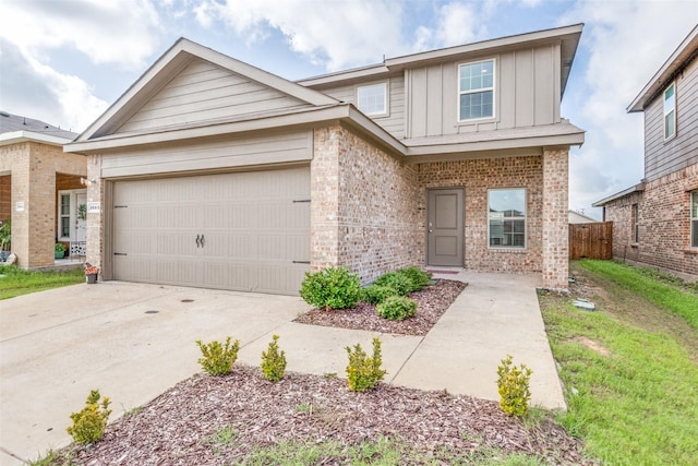 1653 Seadrift Dr, Forney, TX 75126 - view of front of house with board and batten siding, brick siding, concrete driveway, and an attached garage