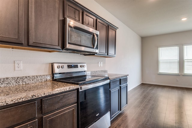 1653 Seadrift Dr, Forney, TX 75126 - kitchen featuring stainless steel appliances, dark brown cabinets, dark wood-style floors, light stone countertops, and recessed lighting