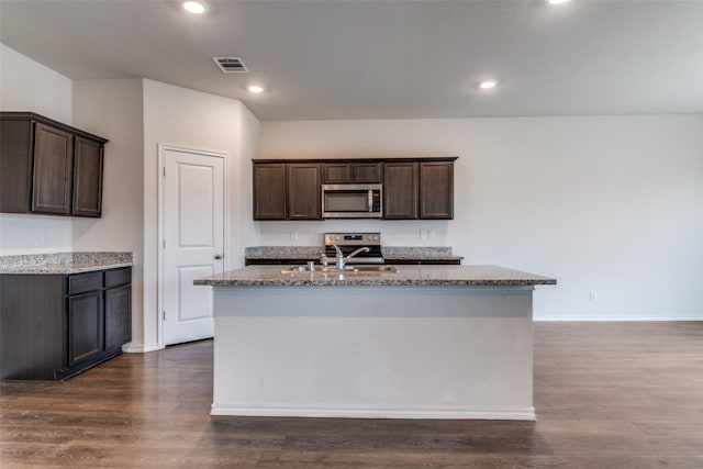 1653 Seadrift Dr, Forney, TX 75126 - kitchen with stainless steel appliances, stone countertops, dark brown cabinets, dark wood finished floors, and recessed lighting