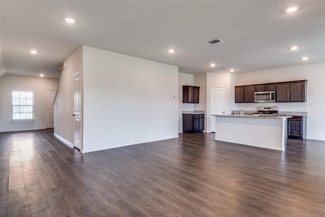 1653 Seadrift Dr, Forney, TX 75126 - unfurnished living room featuring dark wood-type flooring and recessed lighting