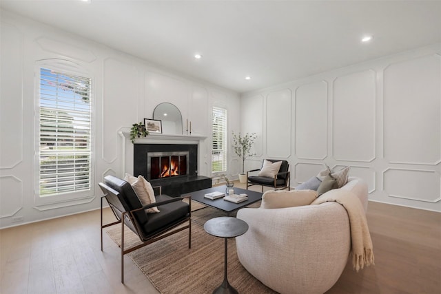 1630 Millview Pl, Carrollton, TX 75006 - living area featuring a decorative wall, light wood finished floors, recessed lighting, and a glass covered fireplace