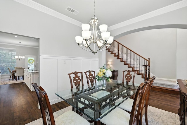 8161 Watson Rd, Lantana, TX 76226 - dining room with a chandelier, crown molding, dark wood-style floors, stairs, and arched walkways
