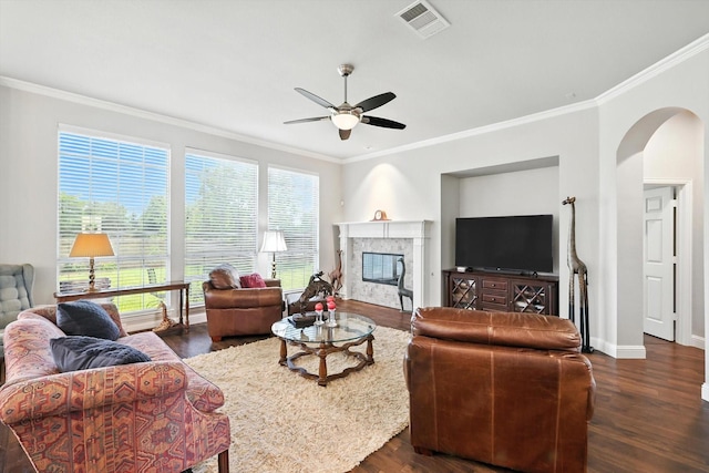 8161 Watson Rd, Lantana, TX 76226 - living room featuring crown molding, ceiling fan, arched walkways, dark wood finished floors, and plenty of natural light