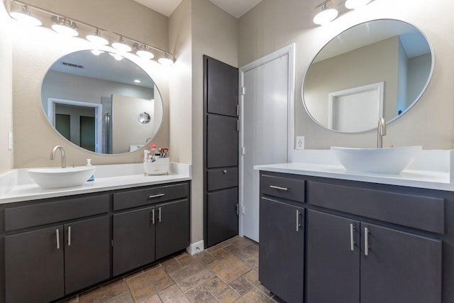 1211 Circle Ln, Bedford, TX 76022 - full bath featuring two vanities and stone tile flooring
