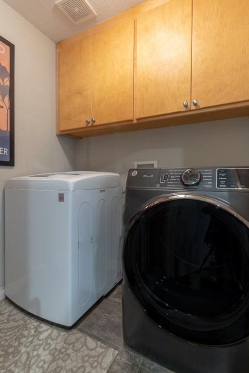 1211 Circle Ln, Bedford, TX 76022 - washroom with cabinet space and washing machine and clothes dryer