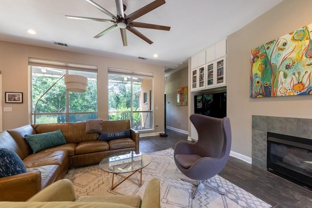 1211 Circle Ln, Bedford, TX 76022 - living area featuring ceiling fan, dark wood finished floors, a tile fireplace, and recessed lighting