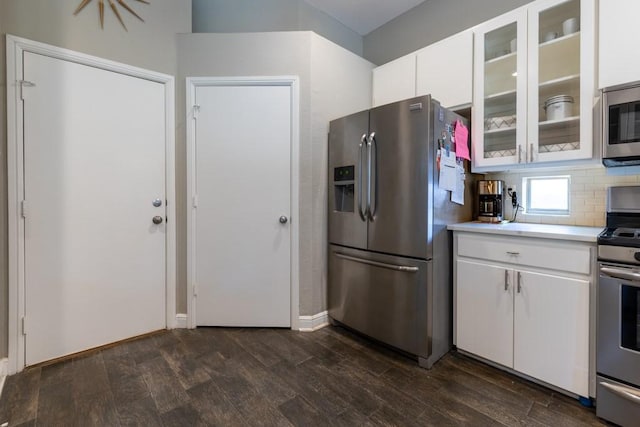 1211 Circle Ln, Bedford, TX 76022 - kitchen with stainless steel appliances, light countertops, dark wood-type flooring, and white cabinets