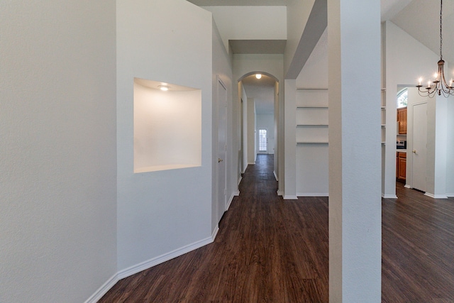 6736 Braeview Dr, Fort Worth, TX 76137 - corridor with arched walkways, dark wood-type flooring, a high ceiling, healthy amount of natural light, and a chandelier