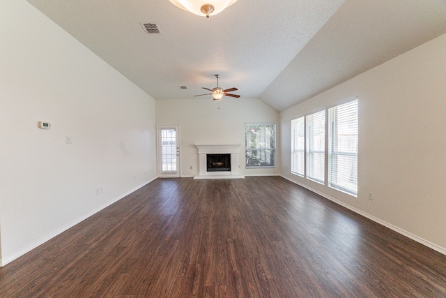 6736 Braeview Dr, Fort Worth, TX 76137 - unfurnished living room featuring a ceiling fan, dark wood-type flooring, lofted ceiling, and a fireplace with raised hearth