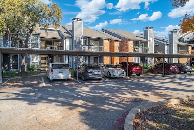 18333 Roehampton Dr Unit 513, Dallas, TX 75252 - covered parking lot featuring a residential view
