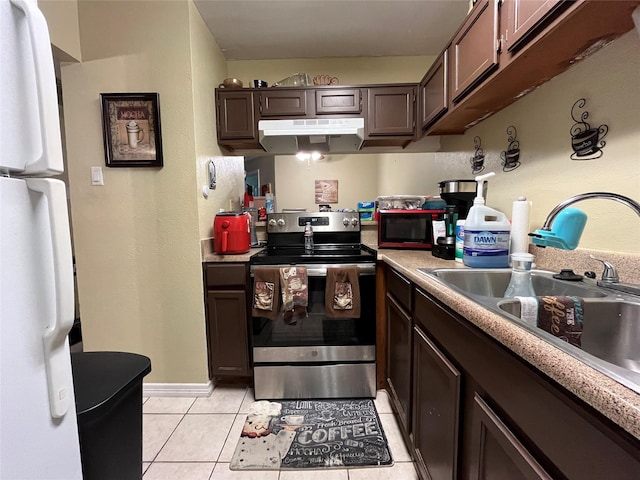 18333 Roehampton Dr Unit 513, Dallas, TX 75252 - kitchen featuring electric range, freestanding refrigerator, under cabinet range hood, light tile patterned floors, and light countertops