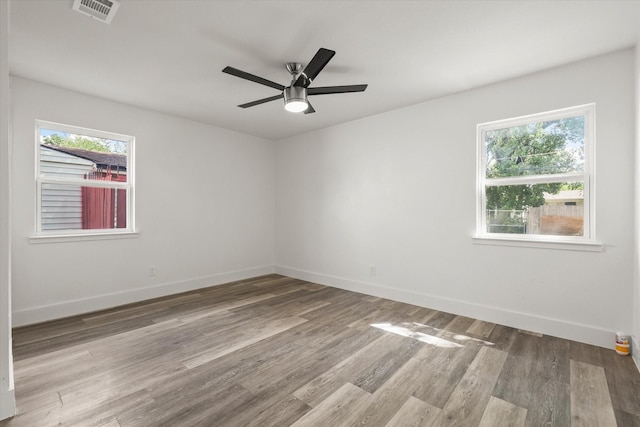 4807 Bedford Dr, Mesquite, TX 75150 - unfurnished room with healthy amount of natural light, wood finished floors, and a ceiling fan