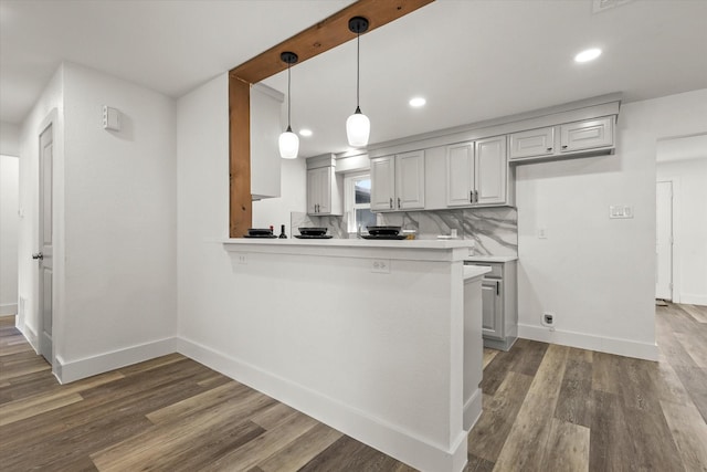 4807 Bedford Dr, Mesquite, TX 75150 - kitchen featuring light countertops, wood finished floors, recessed lighting, pendant lighting, and a peninsula